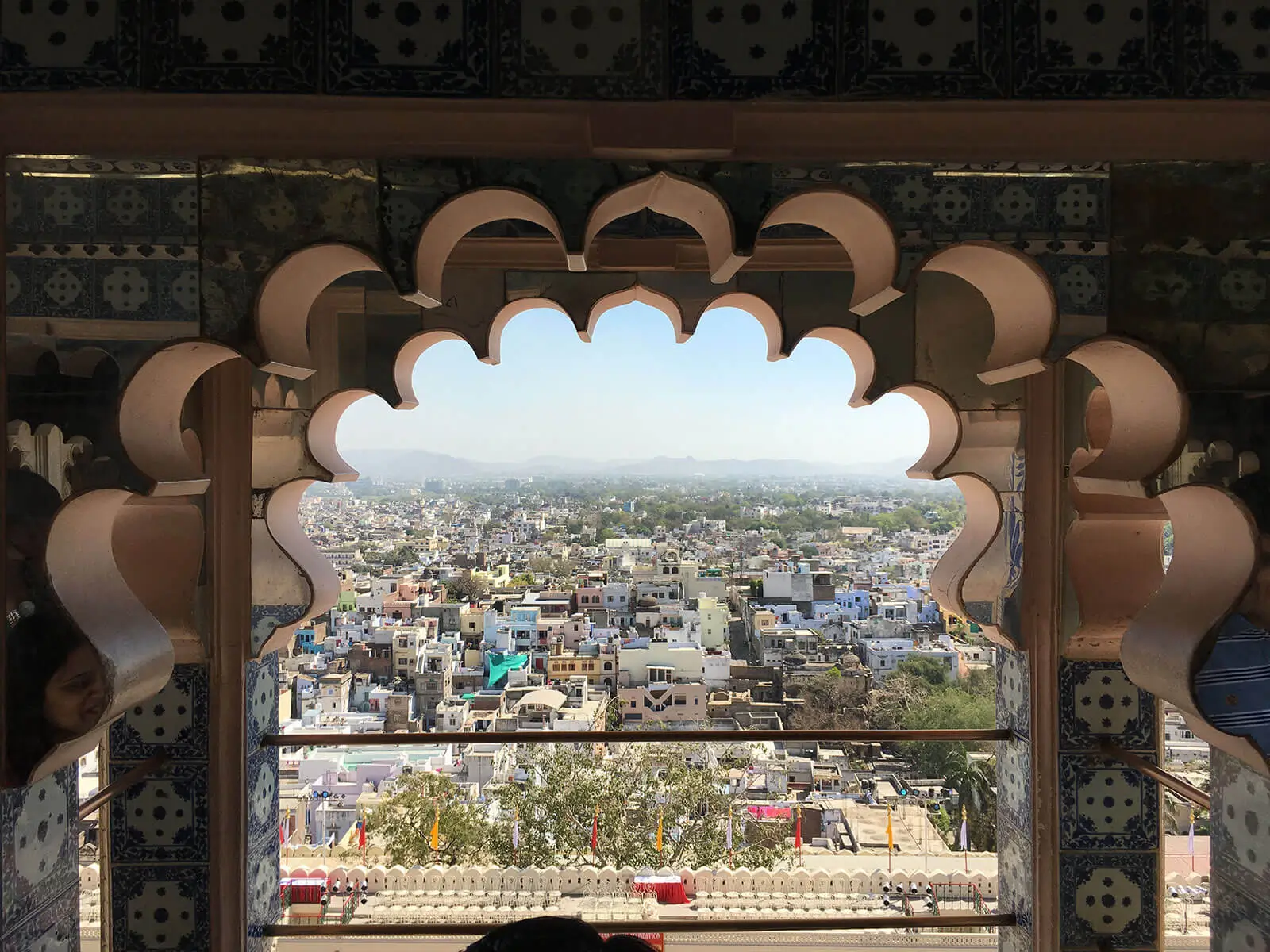 Looking out from a balcony to an indian city below