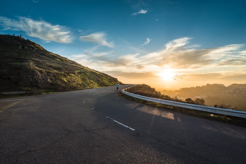 man jogging on street at sunrise